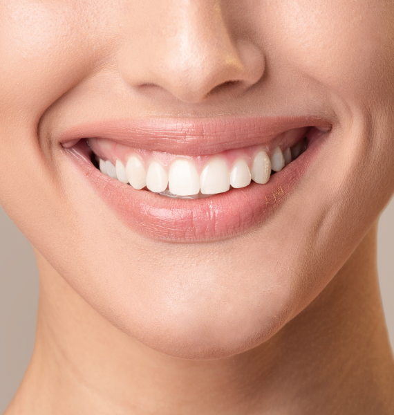 Smiling woman outside with healthy teeth